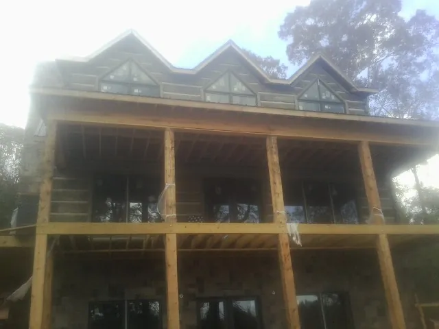 Dormers and porch framing on a large log home under construction in Onalaska