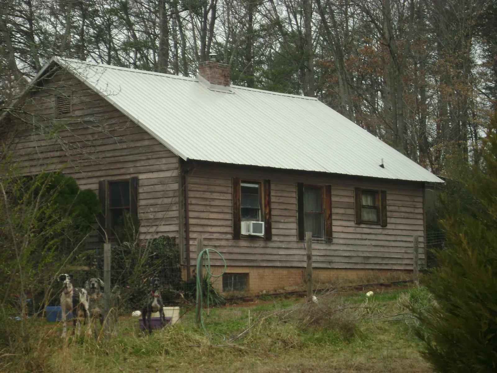 White metal roof on an old wood sided farmhouse, from a Metal Roof Installation job in Onalaska